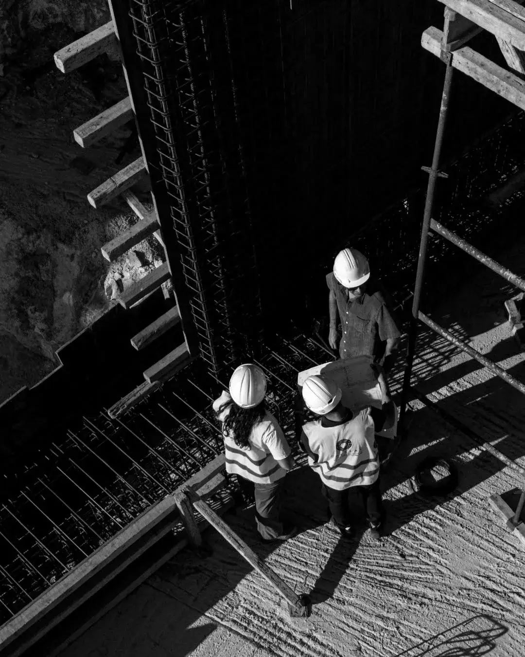 Site team on the scaffolding stair beside a reinforced core